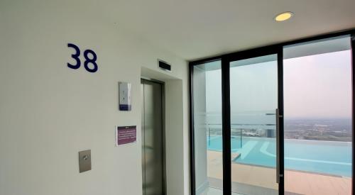 a building with a view of a swimming pool at Comfy Plum West Gate Condo 1 BR in Ban Bang Krabu
