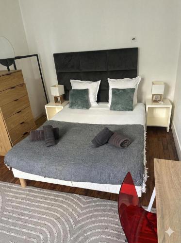 a bedroom with a large bed with two night stands at Paris Défense T2 Design in Suresnes