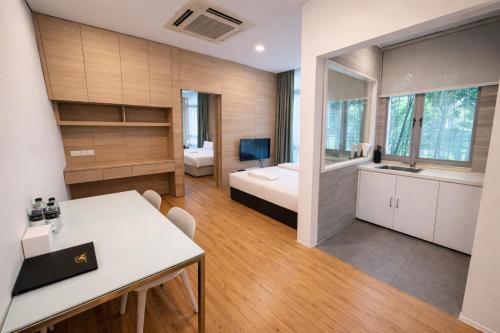a large room with a bed and a desk in it at Oxley Thanksgiving Residence in Singapore