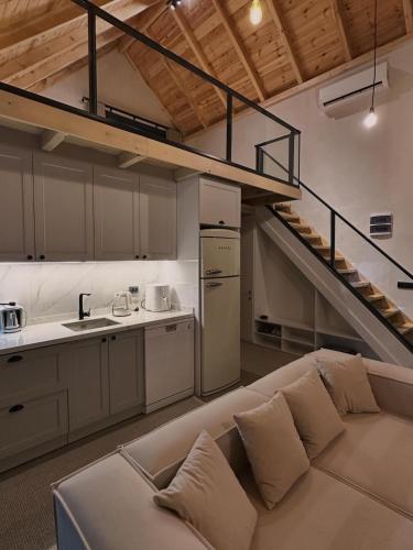 a living room with a couch and a staircase at Çavdi Villa in Ardeşen