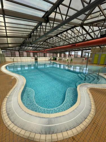 a large swimming pool in a large building at 6 Berth on John Fowlers (Sandy Glade) Brean in Berrow