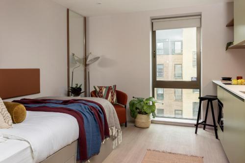 a bedroom with a bed and a window at The Pepper Mill - Campus Residence in Edinburgh