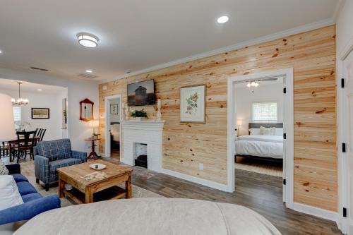 a living room with a fireplace and a bedroom at Mimosa Cottage - Thomasville Charm in Thomasville