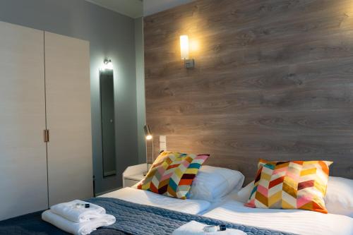 a bedroom with a bed and a wooden wall at Villa Flaming in Sopot