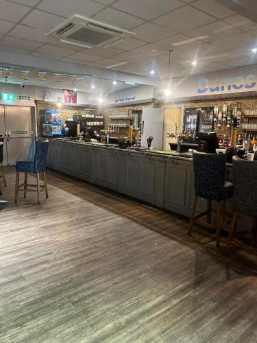 a restaurant with a bar with chairs and a counter at 6 berth pet friendly caravan on Sandy Glade (John Fowlers) Brean in Berrow