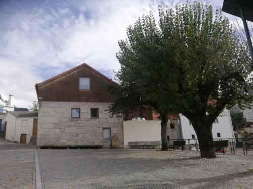 a building with a tree in front of it at Sambuc'asa - Serra da Estrela in Sabugueiro