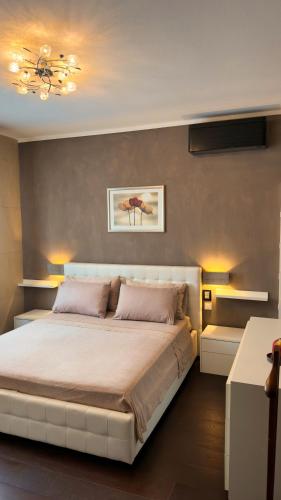 a bedroom with a large white bed with two pillows at Giulia By The Sea in Follonica