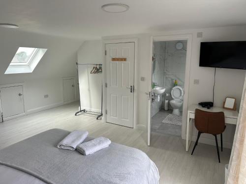 a white bedroom with a bed and a bathroom at Beautiful home in Oxford in Oxford