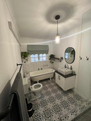 a bathroom with a tub and a toilet and a sink at Maple and Vine in Hilton
