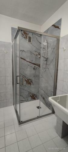 a shower with a glass door in a bathroom at Casa GALLI Como in Colverde