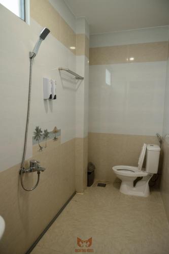 a bathroom with a shower and a toilet at Bich Thu Hotel in Ho Chi Minh City