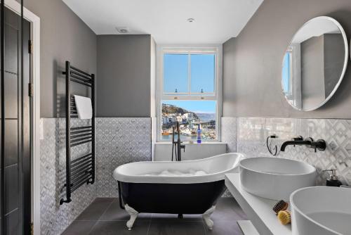 a bathroom with a tub and a sink at Leader Suite - Sea View - Free Wi-Fi in Brixham
