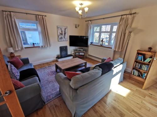 a living room with a couch and a table at Unbeatable Llanberis Location, Detached with Parking, Snowdon Views. in Llanberis