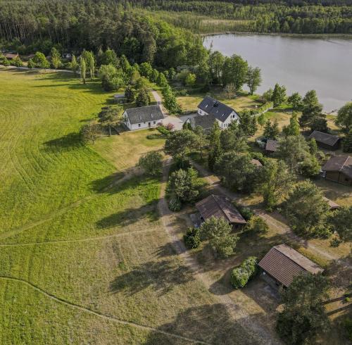 an aerial view of a house on the shore of a lake at Ferienhaus-Park Brennickenswerder in Lychen