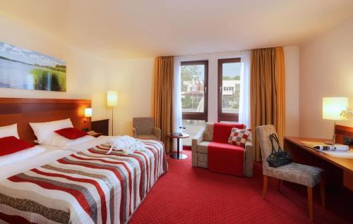 a hotel room with a bed and a desk at A&S City Hotel am Rosenpark in Aachen