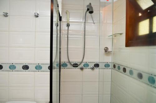 a bathroom with a shower and a sink at Hotel Girassol in Penedo