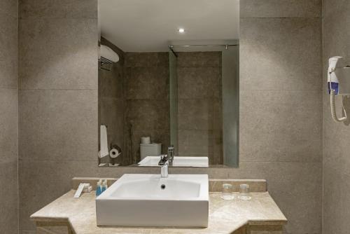 a bathroom with a sink and a mirror at Blend Elphistone Resort Marsa Alam in Abu Dabbab