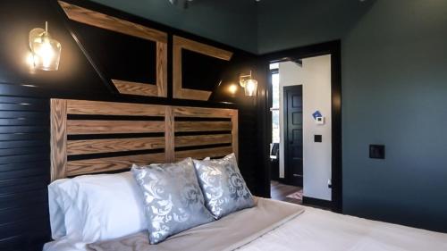 a bedroom with a large bed with a wooden headboard at Modern Queen Apartment At The Victorian Unit E in Muskegon