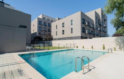 a swimming pool in front of a building at Fancy Studio with Terrace & Pool - Madrid South in Villaverde