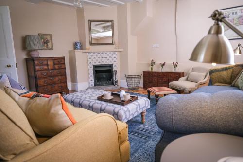a living room with two couches and a fireplace at Challens Yarde in Midhurst