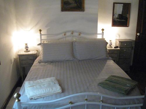 a bedroom with a bed with two towels on it at Quinta do Rossio, Rural Tourism in Biscoitos
