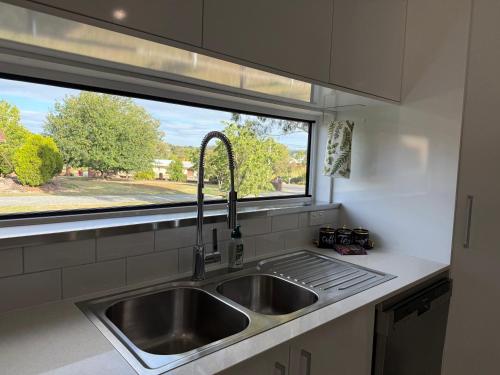 a kitchen with a sink and a window at The Green Shouse in Stanthorpe