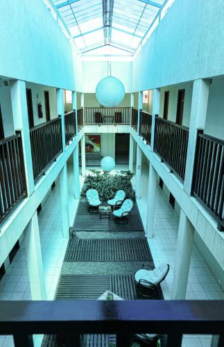 an empty hallway of a building with stools at San Felipe Hotel in Colinas do Tocantins