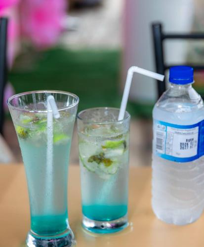 a drink and a bottle of water on a table at Villa Nelith in Galle