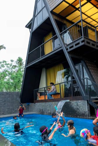 a group of children playing in a swimming pool at Villa Nelith in Galle