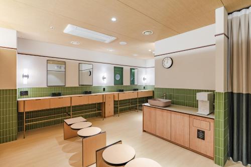 a bathroom with two sinks and two mirrors at Mansion Bridge Cheonan in Cheonan