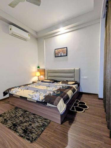 a bedroom with a large bed in a room at Home Bliss BnB in Greater Noida