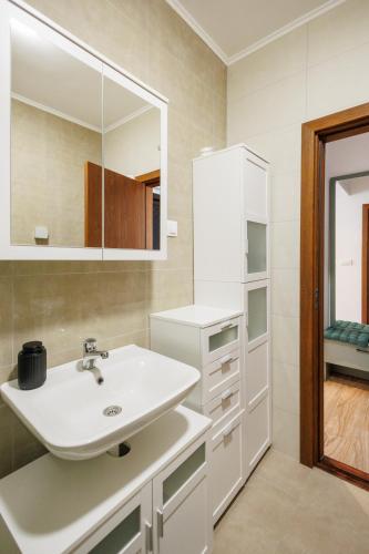 a bathroom with a sink and a mirror at MaxInn 14 in Pirot