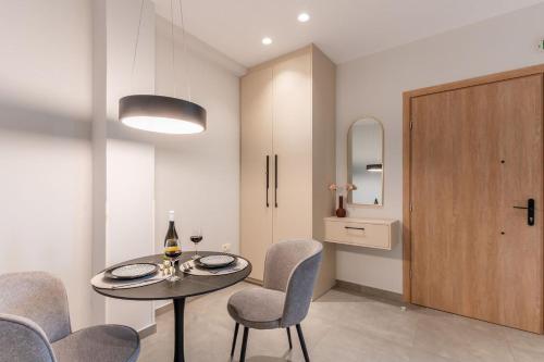 a dining room with a table and chairs and a door at K35 Apartments in Preveza