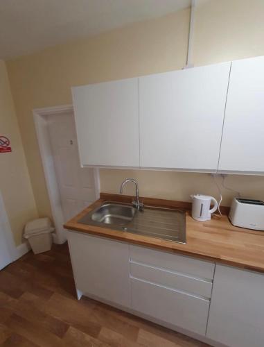 a kitchen with a sink and a counter top at Mersey view Hotel & Pub in Hale