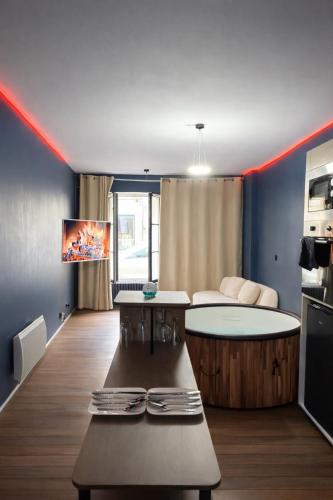 a living room with a table and a kitchen at L'Envers SPA - Suite Romantique Metz Centre in Metz