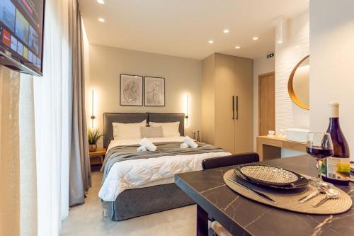 a bedroom with a large bed and a table at K35 Apartments in Preveza