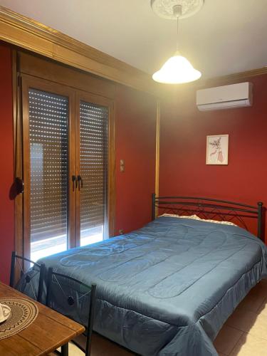 a bedroom with a bed in a room with red walls at Serres central house in Serres