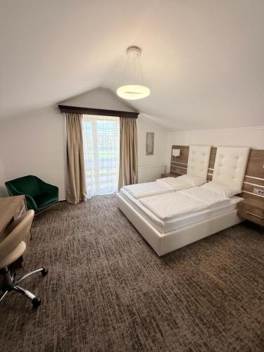 a bedroom with a large white bed and a window at White Residence in Arad
