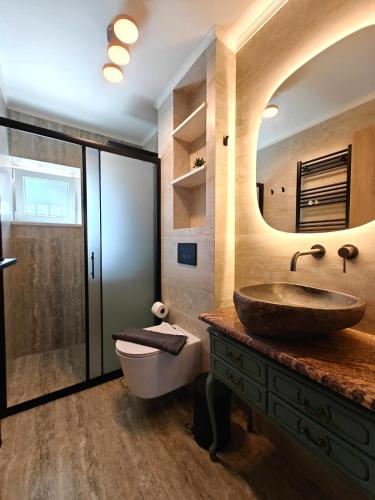 a bathroom with a sink and a mirror at Aria home in Tsoukalades