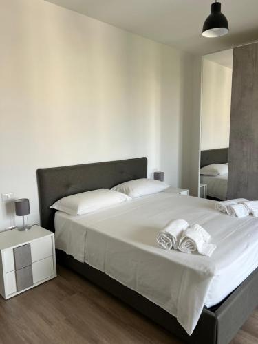 a bedroom with a large bed with two towels on it at Apartment Le Forge in Policoro