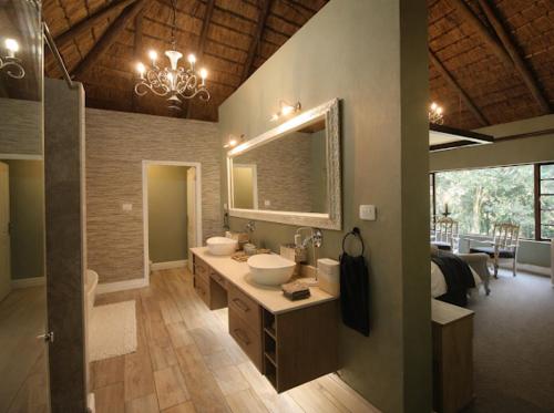 a large bathroom with two sinks and a mirror at Hilton Creek in Hilton