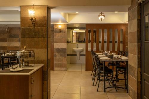 a dining room with a table and chairs at Las Palmas in Munnar
