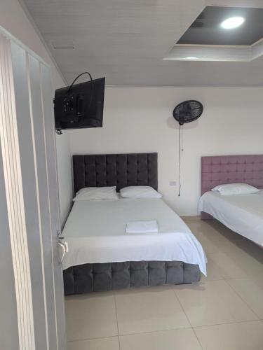 a bedroom with a bed and a tv on the wall at Hotel don Nilo in Albania