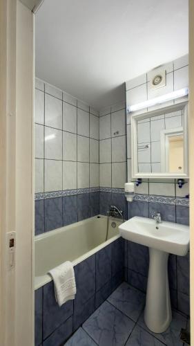 a bathroom with a sink and a bath tub and a sink at Hotel Cetate in Alba Iulia