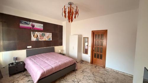 a bedroom with a bed and a chandelier at Casa dell'Aloe in Angri