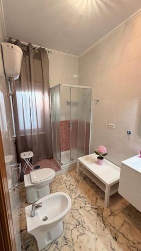 a bathroom with two toilets and a shower and a sink at Casa dell'Aloe in Angri