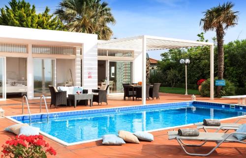 a house with a swimming pool and a patio at Simpson Secret - Epirus Coast in Ligia