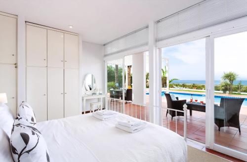 a bedroom with a bed and a view of a pool at Simpson Secret - Epirus Coast in Ligia