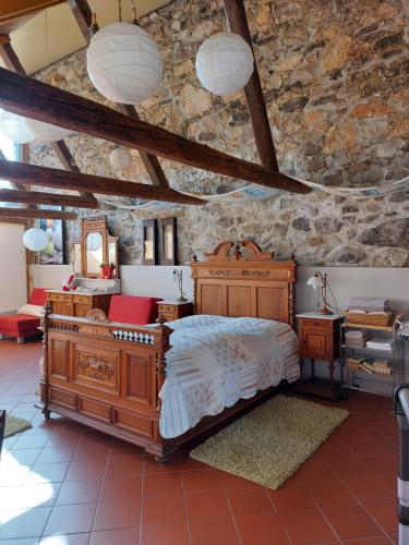a bedroom with a bed and a stone wall at Barthmühle in Klipphausen