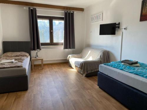 a room with two beds and a chair in it at 3072 Apartment MITTERFELD - Top A in Kasten bei Böheimkirchen